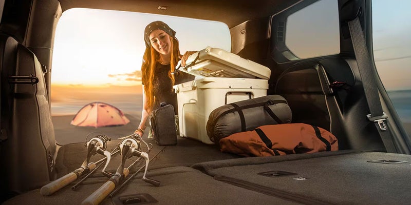 Spacious Jeep cargo area loaded with camping gear and luggage