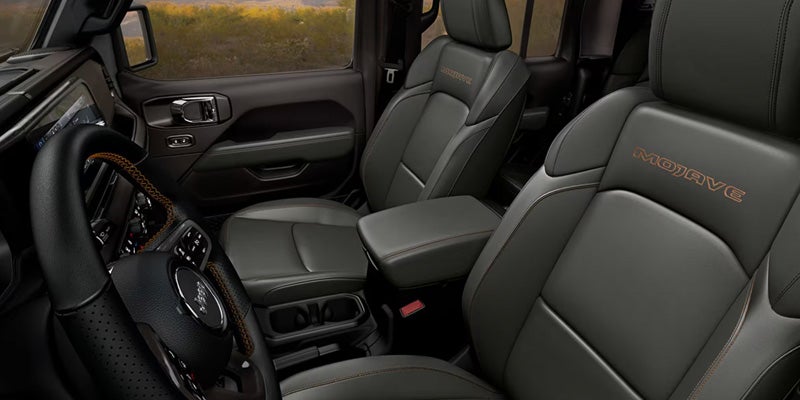 Premium Jeep interior with black leather front seats and center console
