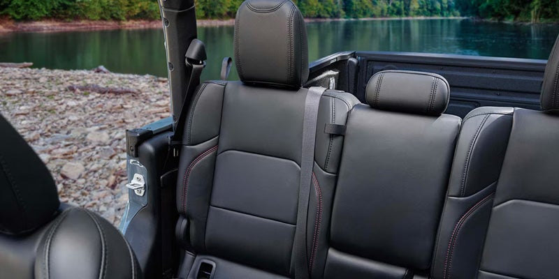 Jeep pickup truck rear seating area with black leather upholstery