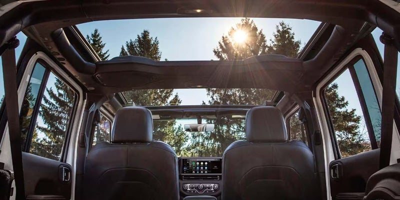 Jeep Wrangler interior with panoramic roof and open-air cabin view