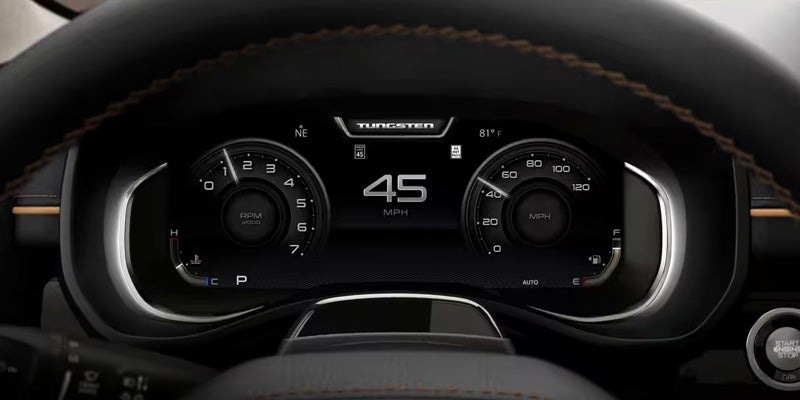 Digital driver information display showing vehicle speed and dashboard gauges